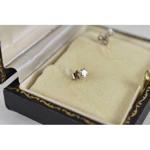 274 - A pair of 18ct gold and diamond earrings, 1.1g, with original case.