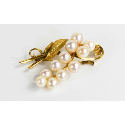 284 - A 14ct gold and pearl brooch, in the form of a spray of berries and foliage, 9.8g.