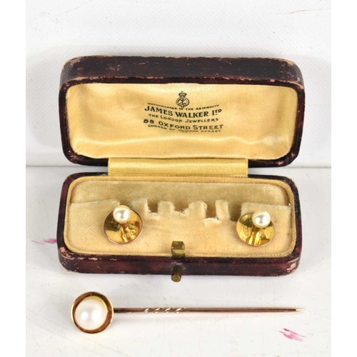 285 - A pair of 9ct gold and pearl shirt studs together with a gold and pearl stick pin, 4.7g.