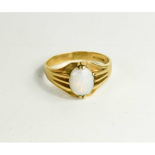 286 - A 9ct gold and opal ring, circa 1970, the oval opal 10mm by 7mm, size Y, 4.82g.