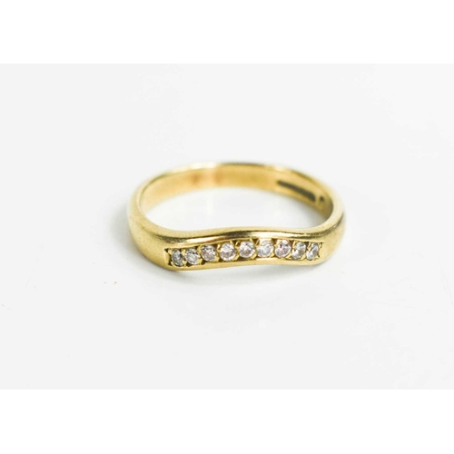 288 - A 9ct gold and diamond ring, with nine brilliant cut diamonds, shaped to fit alongside an engagement... 