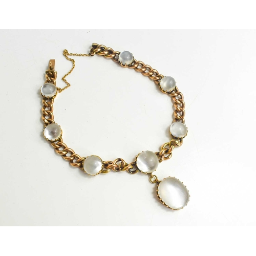 300 - A 9ct gold and moonstone bracelet, the chain link set with seven cabochon moonstones and an oval pen... 