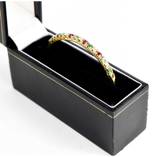 305 - An 18ct gold, diamond, emerald and pink sapphire bangle, fifteen brilliant cut stones in total, with... 