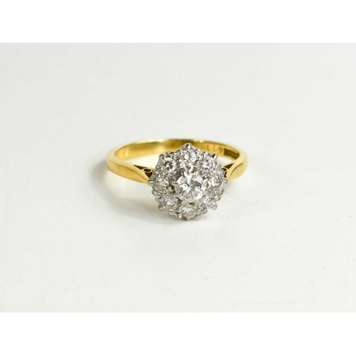 306 - An 18ct gold, diamond and cluster ring, the central diamond approximately 1/8ct, 2.98g.