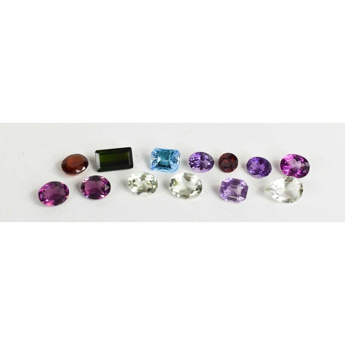 310 - A quantity of loose gemstones, to include topaz, amethysts, garnet and various others.