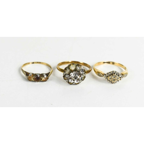 323 - A 9ct gold and paste ring, 1.36g, a rolled gold paste ring and a 15ct gold and diamond lozenge form ... 