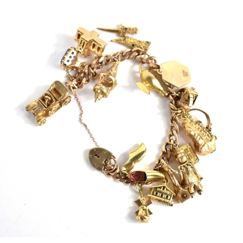 332 - A 9ct gold chain link charm bracelet, with seventeen 9ct gold charms including motorcar, amethyst se... 