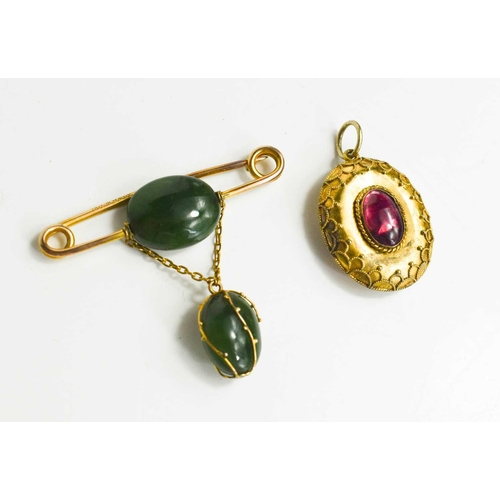 341 - A 9ct gold and jade brooch, the gold pin centred by a an oval jade bead with suspended pendant oval ... 