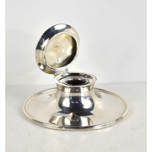 345 - A silver capstan inkwell with clear glass liner, hallmarked for Birmingham 1945.