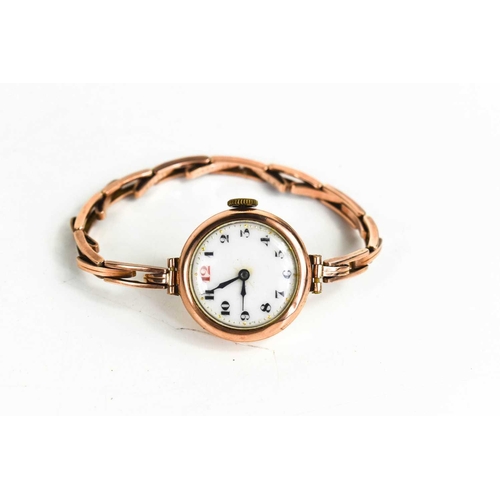 374 - A 1920s 9ct rose gold wristwatch, with an Arabic dial, with a 9ct gold stretch link strap, 17g total... 