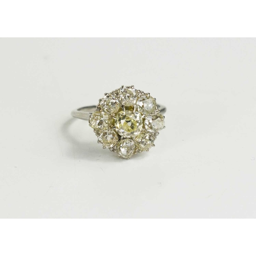 4 - An 18ct white gold and diamond flowerhead ring, composed of old cut diamonds, the central approximat... 