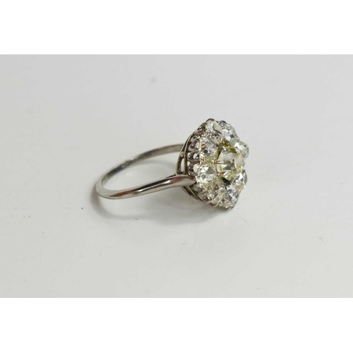 4 - An 18ct white gold and diamond flowerhead ring, composed of old cut diamonds, the central approximat... 