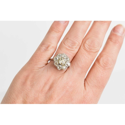 4 - An 18ct white gold and diamond flowerhead ring, composed of old cut diamonds, the central approximat... 