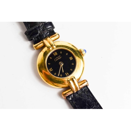 43 - A Must de Cartier 1980s silver gilt wristwatch with the original black leather strap, numbered 59000... 