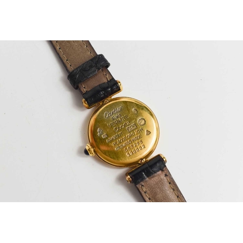 43 - A Must de Cartier 1980s silver gilt wristwatch with the original black leather strap, numbered 59000... 