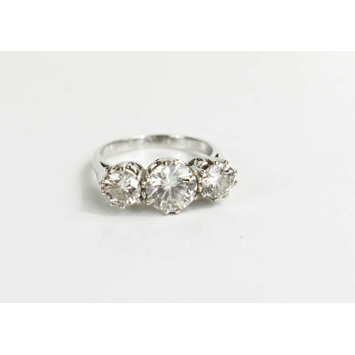 5 - A stunning 18ct white gold and diamond three stone ring, the central brilliant cut diamond approxima... 