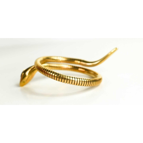 6 - A 9ct gold snake form bracelet, set with ruby eyes, and composed of articulated links terminating wi... 