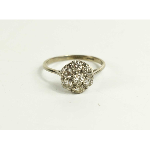 61 - An 18ct white gold, and diamond flowerhead ring, size Q, 2.85g.