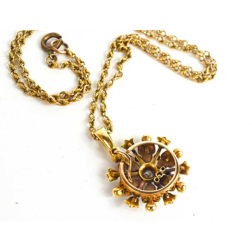 64 - A 15ct gold rope twist necklace, with diamond and seed pearl set pendant in the form of a snowflake ... 