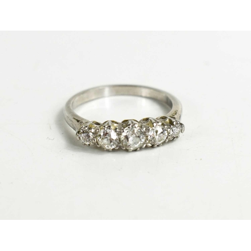 65 - A platinum and diamond five stone ring, the brilliant cut diamonds of graduated form, claw set, appr... 