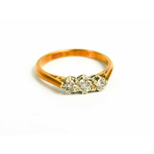 67 - An 18ct gold and three stone diamond ring, illusion set brilliant cut diamonds, size M, 2.92g.