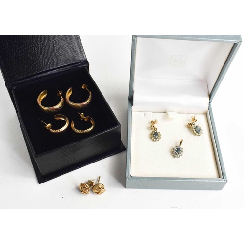 77 - Two pairs of 9ct gold hoop earrings, a pair of 9ct gold swirl form earrings, and a pair of 9ct gold ... 