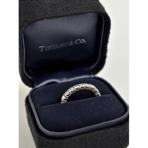 80 - A Tiffany & Co platinum and diamond full eternity ring, set with twenty one brilliant cut diamonds a... 