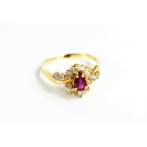 83 - A 14ct gold, ruby and diamond ring, the pear cut ruby bordered by brilliant cut diamonds, size M, 2.... 