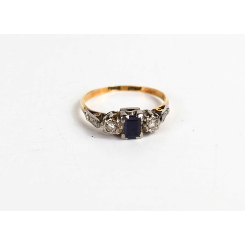 85 - An 18ct gold sapphire and diamond ring, the rectangular cut sapphire flanked by two illusion set rin... 