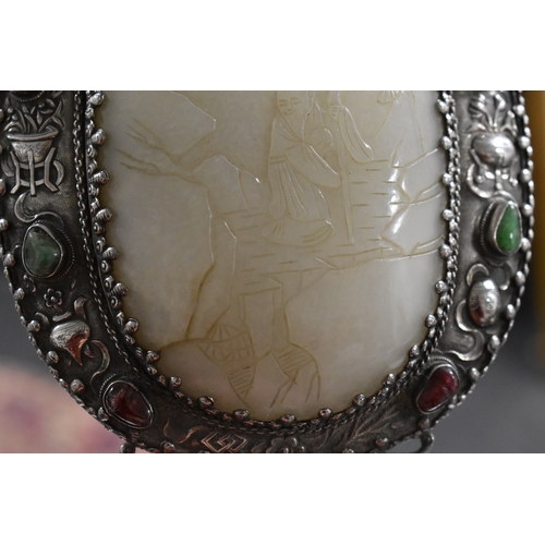 26 - A Qing Dynasty (1644-1912) Chinese white metal and jade hand mirror, comprising a large openwork bel... 