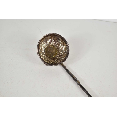 13 - A George II white metal toddy ladle, the bowl with embossed foliate decoration and set with a George... 