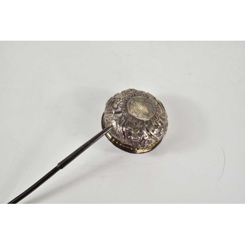 13 - A George II white metal toddy ladle, the bowl with embossed foliate decoration and set with a George... 