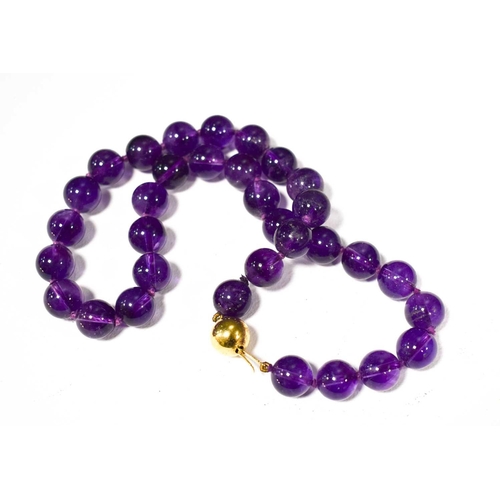 151 - A 9ct gold and amethyst bead necklace, the ball form clasp the same size as the amethyst beads, 45cm... 