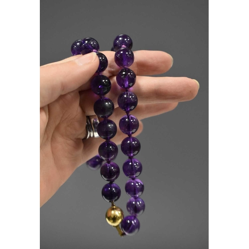 151 - A 9ct gold and amethyst bead necklace, the ball form clasp the same size as the amethyst beads, 45cm... 