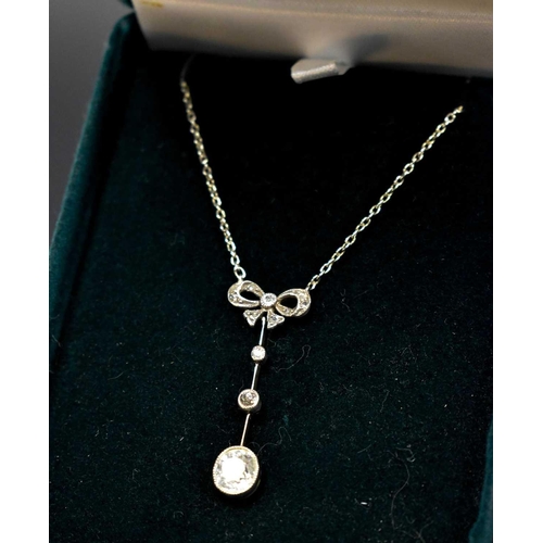 154 - An antique 9ct white gold pendant necklace, the old cut diamond approximately 1ct, suspended beneath... 