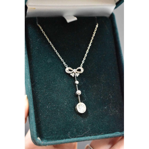 154 - An antique 9ct white gold pendant necklace, the old cut diamond approximately 1ct, suspended beneath... 