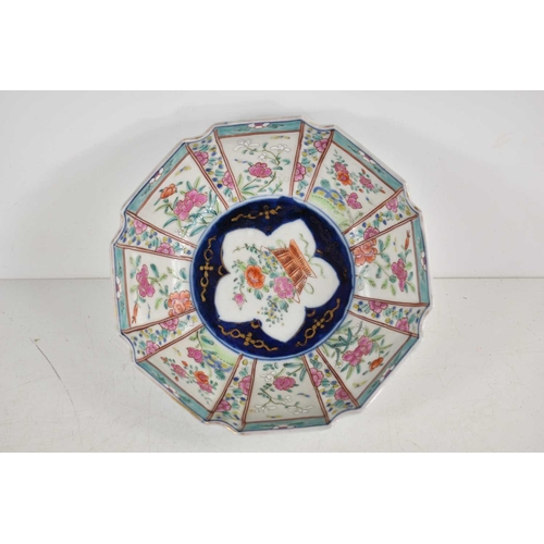 191 - An Oriental bowl decorated with panels of flowers, cut rim with flower basket cartouche, 17.5cm wide... 