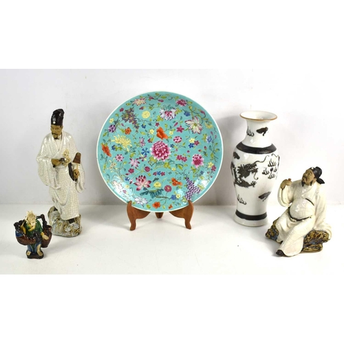 206 - A group of Asian pottery to include three stoneware Japanese figures, a Chinese charger decorated wi... 