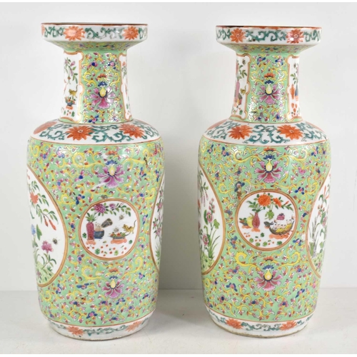 256 - A pair of early 20th century Chinese vases, decorated with flowers, bats and insects, 35cm high.