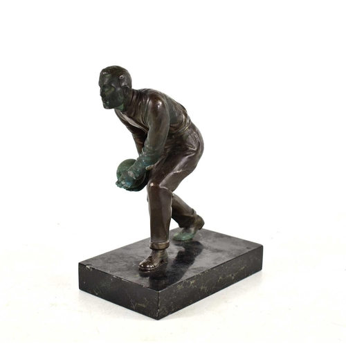 257 - An Art Deco bronze sculpture of a man bowling in the style of Schmidt Hofer, raised on a marble base... 