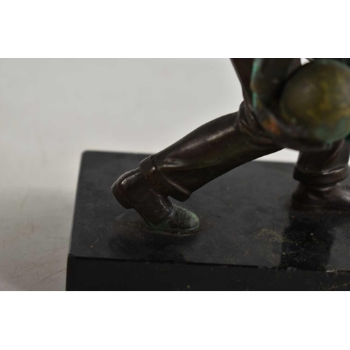 257 - An Art Deco bronze sculpture of a man bowling in the style of Schmidt Hofer, raised on a marble base... 