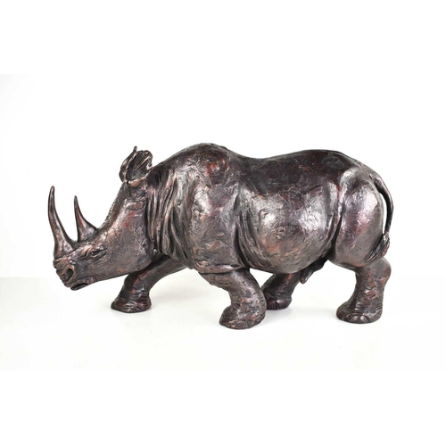 260 - A bronzed resin rhinoceros sculpture in the style of a Johnathan Sanders Frith Sculpture, 40cm long.