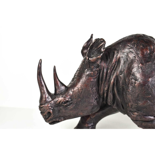 260 - A bronzed resin rhinoceros sculpture in the style of a Johnathan Sanders Frith Sculpture, 40cm long.