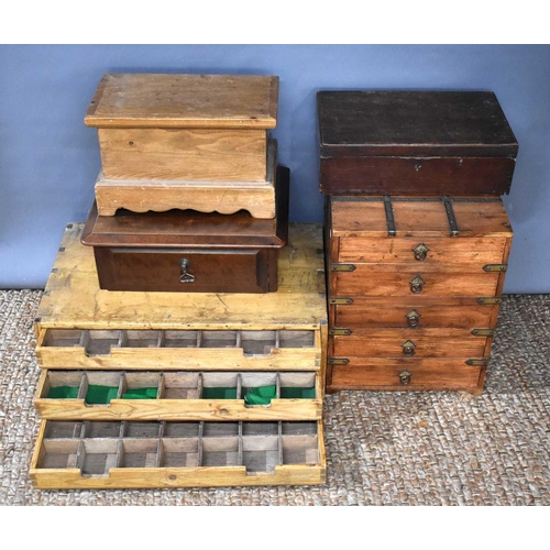 265 - A group of treen boxes and cabinets to include a pine three drawer cabinet with fitted compartments,... 