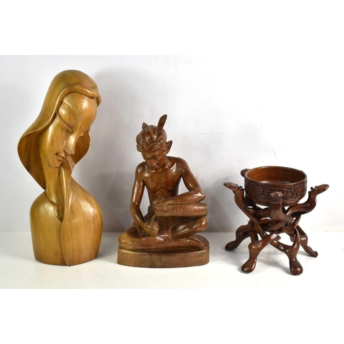 270 - Three Asian wooden carvings, to include a Bali male seated figure, a bowl on stand composed of inter... 