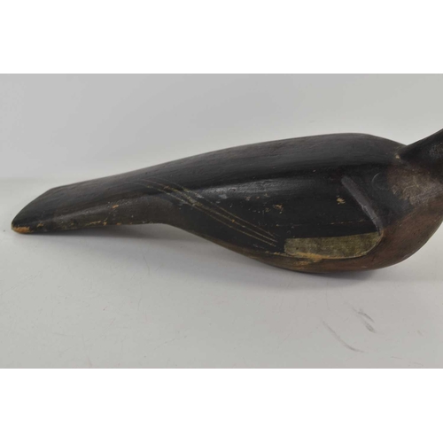 273 - An antique wooden painted pigeon decoy with carved body and beak with inset black and white glass ey... 