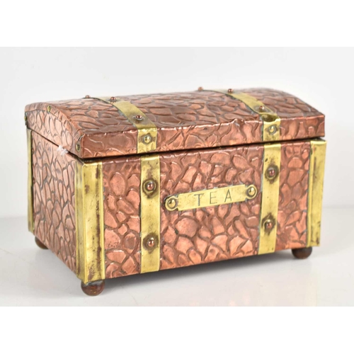 277 - An Arts and Crafts copper and brass bound tea caddy of domed rectangular form with textured finish a... 