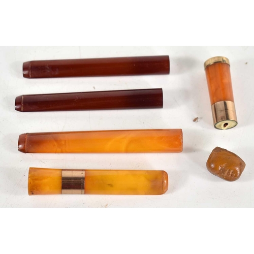 278 - A group of amber cigarette holders, two having yellow metal bands.