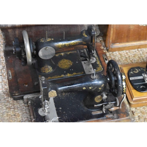 281 - Three antique Singer sewing machines.