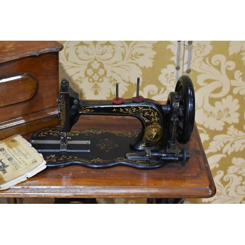 286 - A Bradbury & Co Victorian Sewing machine on stand with the original booklet.